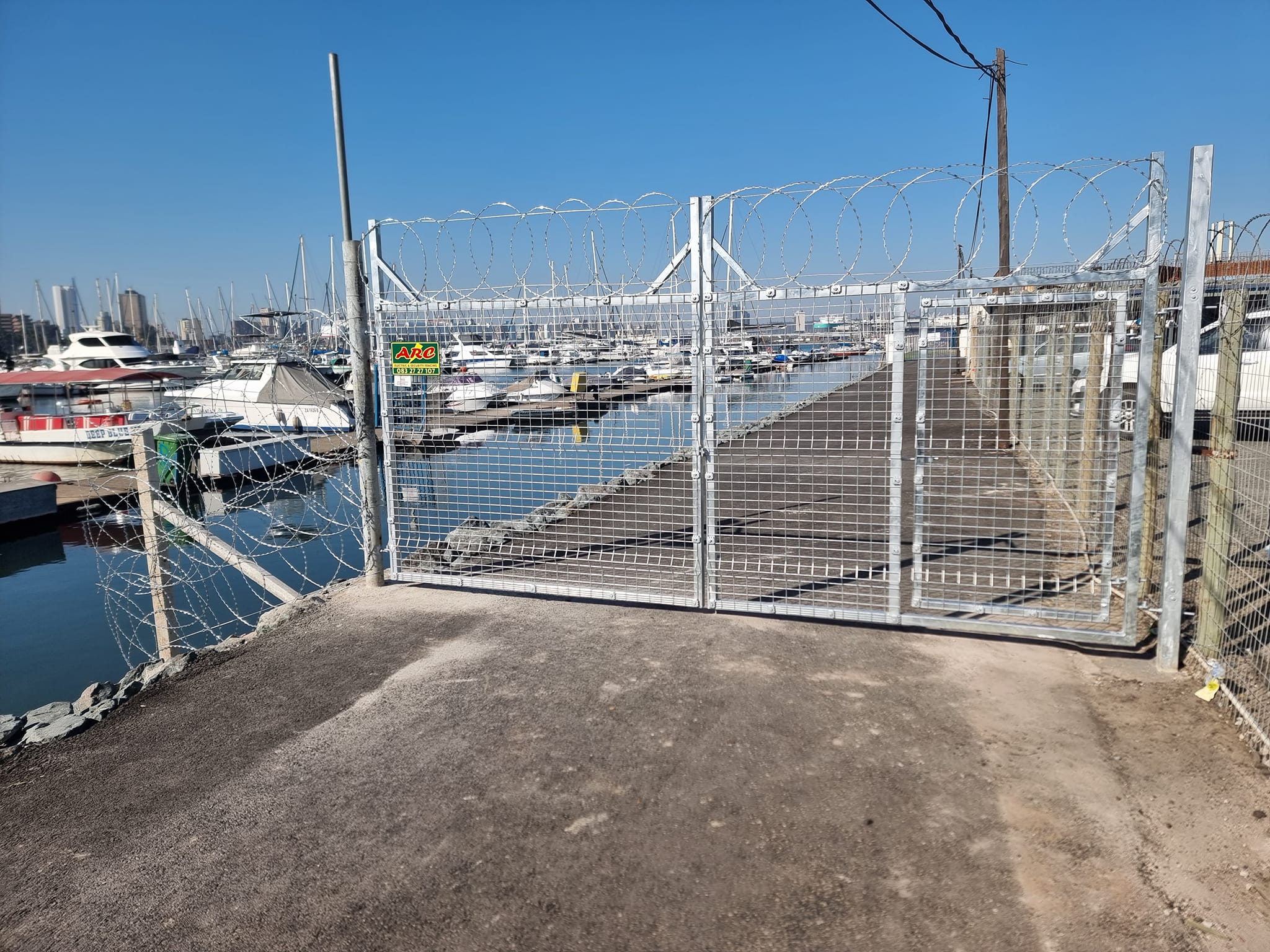 Marina security gate with razor wire